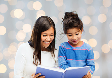 幸福的母亲和小女儿阅读书本图片