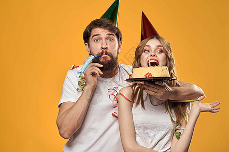 男人和女人的生日节日蛋糕 黄色背景和头盖帽 快乐的 假期图片
