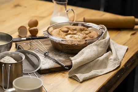 橡木桌上的美味苹果派 配料 在阁楼风格的厨房里烹制美味的苹果派 牛奶 鸡蛋 糖和桌上的烤馅饼 家庭厨房 水果 甜的图片
