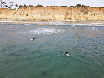 冲浪者穿着潜水衣划水 享受大浪 美国加利福尼亚州圣地亚哥 海洋 天空图片