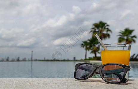 泳池旁边的放松时刻 休息一会吧 享受新鲜橙汁喝点饮料吧 茶点 反射图片