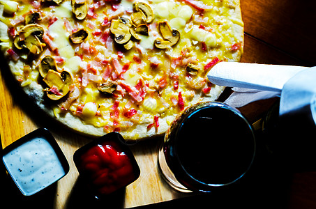 红酒和美味的比萨饼 还有培根 火腿 蘑菇 蔬菜 盘子图片