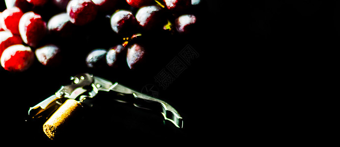 佳美娜葡萄黑底大红葡萄水果旁的蜗牛上装着软塞的corkscrew 赤霞珠 喝背景