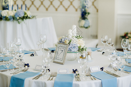 节庆桌用浅色的彩色装饰 配有蓝色餐巾纸和鲜花 没有食物 眼镜 派对图片