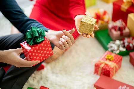 男女亲近地握着礼物或礼品盒 用于圣诞节或新年庆祝活动 掌声乐趣高清图片素材
