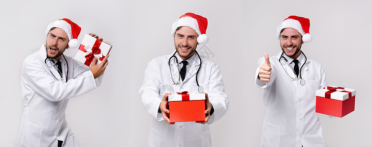身穿白制服和圣诞老人帽子的英俊年轻医生 站在工作室中 用白色背景微笑和手指进行照相 关心 男人图片