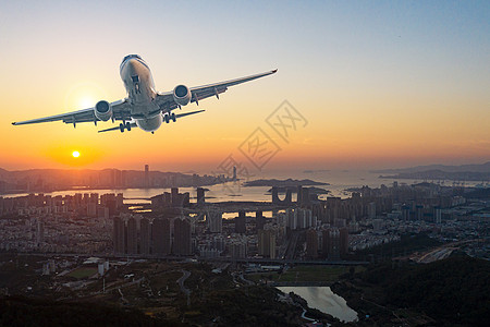 飞机黄昏城市上空的飞机设计图片