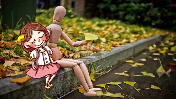 秋天银杏树下的人偶图片