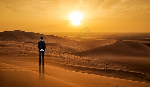 一个人走在沙漠背景图片