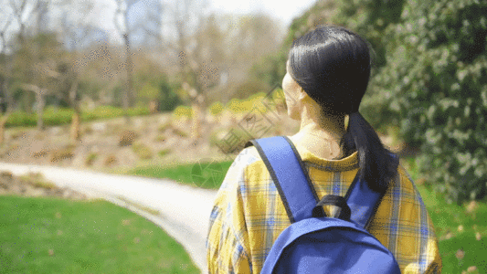 头发背影背着书包的女生户外郊游背影GIF高清图片