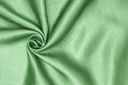 优雅的绿色丝绸或席恩奢侈布质素可用作抽象背景卷起的织图片