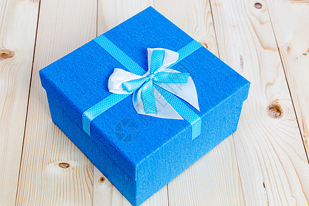 木制背景蓝色缎带礼物盒高清图片