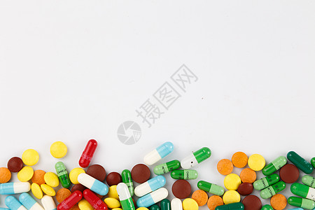 各种颜色彩色的药片和胶囊背景图片