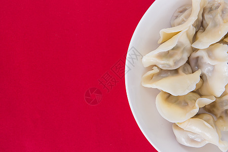 中国冬至简洁红色喜庆背景的热饺子背景图片