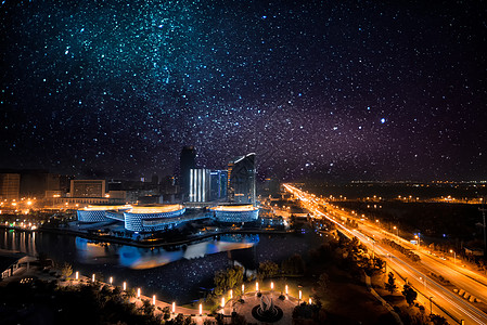 蓝紫背景星空下的城市夜景背景