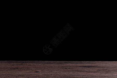 纹理黑色木制桌面和黑背景背景