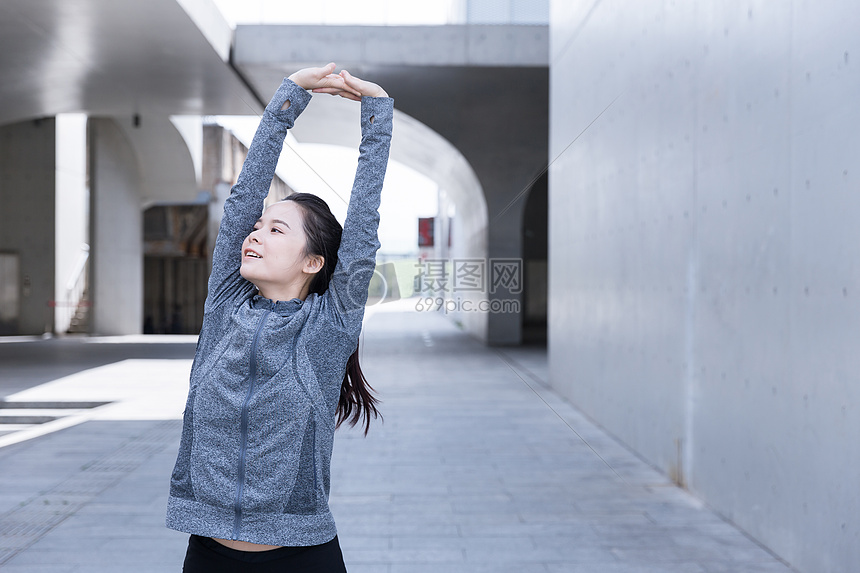 户外运动健身女孩热身拉伸图片