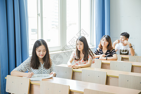 在窗户前的男孩校园教室同学们在写卷子背景