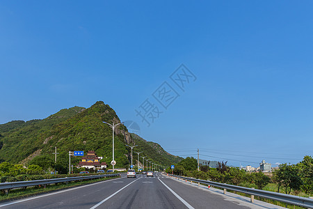 蓝天下的大气宽广依山公路背景图片