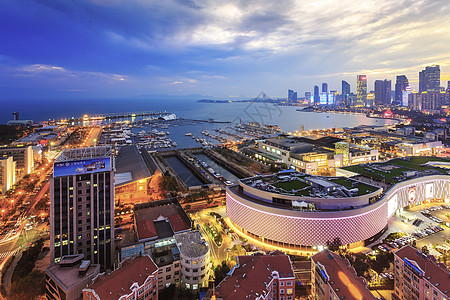 海边日落繁华海滨城市夜景背景