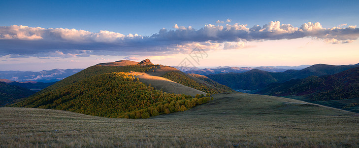 山上树林夕阳下的山峰光影全景背景