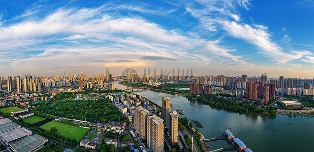 城市江边蓝天白云下的武汉城市高楼河滨全景背景