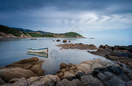 海边旅行插画蓝天白云下的岩石小船背景