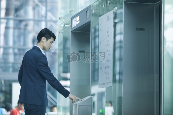 商务男生在机场等待电梯图片