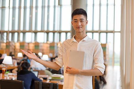 拿书仙子同学图书馆拿着书欢迎大家背景