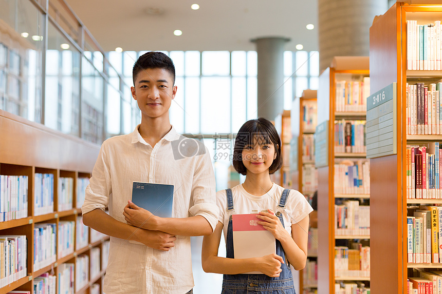 青春男女同学在图书馆学习看书讨论图片