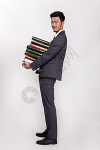 抱着一大堆书的商务人士图片