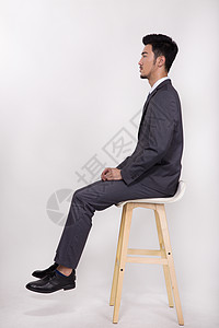 坐在椅子上的男人坐在椅子上的商务人士背景