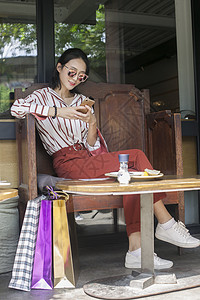 时尚女性在购物小资美女在逛街购物之余休息背景