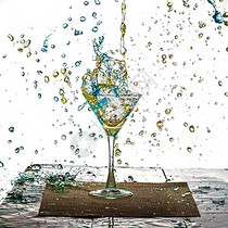蓝色与黄色的饮料在杯中溅出水珠图片