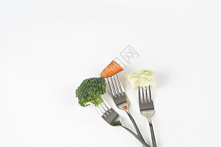 叉子叉着蔬菜背景图片