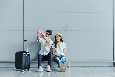 机场热恋情侣休息自拍背景图片