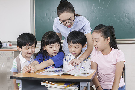 小学生上课讨论女老师和同学们在教室一起学习背景