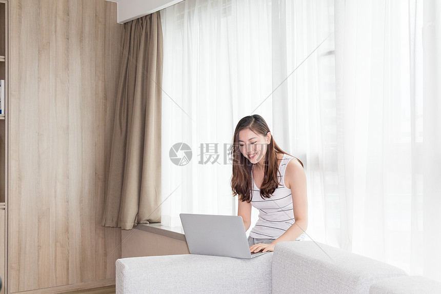 年轻女性在客厅使用家庭办公图片