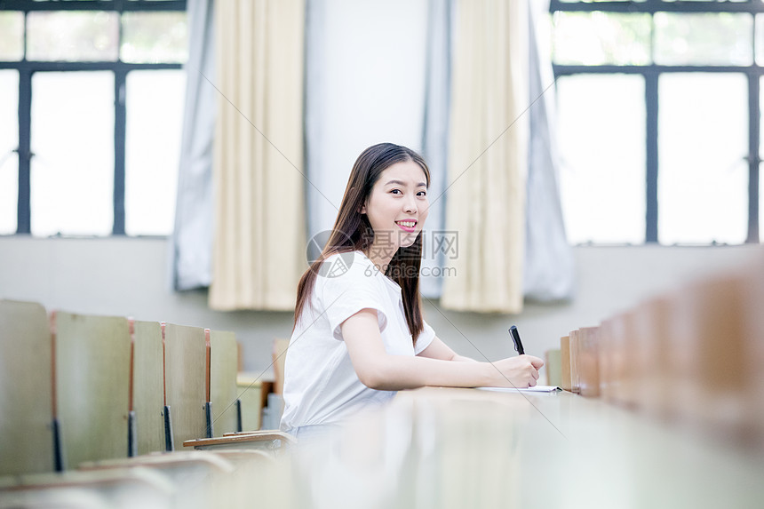 教室里正在学习写字的女生同学图片