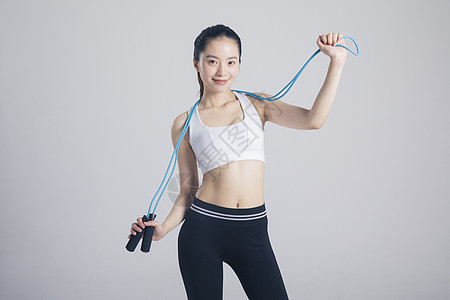 运动美女跳绳运动的健身女性背景