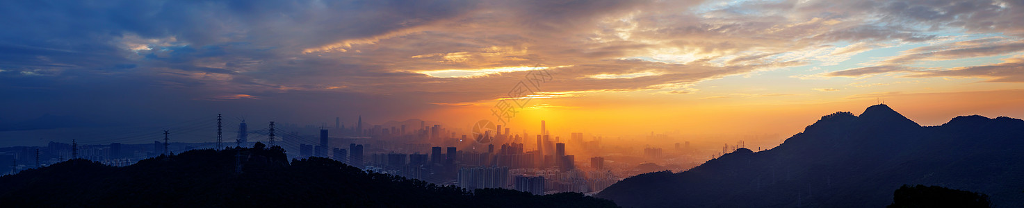 海边逆光城市海湾山脉夕阳背景