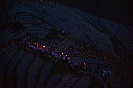 广西龙脊梯田火把节梯田烛光火把夜景背景图片