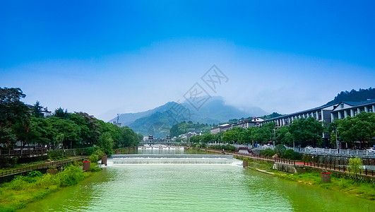 河道绿化蓝天白云下的房屋河道河流背景