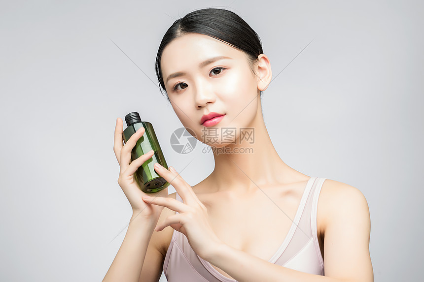 性感美女手持精华乳液瓶装图片