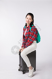 背着书包拉着行李箱的年轻女性图片