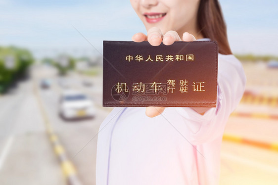 拿着驾驶证的女性