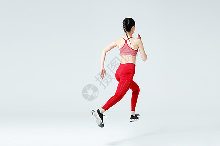 健身女性跑步冲刺背影背景图片