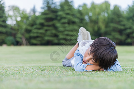 孩子睡觉可爱儿童趴在草地上休息背景