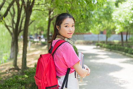 抱着书的学生大学生抱着书本背景