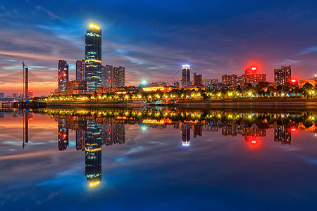 办公楼夜景夕阳下武汉汉江边城市夜景江景背景